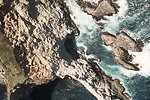  Unidentified rock headland with sea cave. 