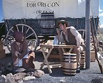 Rebecca Crow and Brandon Kames portray a pioneer couple at a wagon encampment.