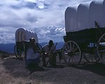 Nancy Harms and Dylan Prichertt portray pioneer woman and a black pioneer at an Oregon Trail wagon encampment.