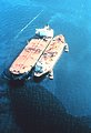  EXXON VALDEZ aground on Bligh Reef being lightered to reduce oil spillage and lighten ship to get off reef. 