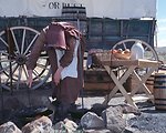 Rebecca Crow portrays a pioneer woman cooking on the Oregon Trail.