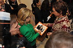 Secretary Clinton Signs a Photo for Public Affairs Assistant Muradova