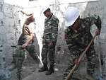 Utilitiesman 2nd Class (SCW) Dines Demonstrates for Timorese Defense Force F-FDTL Workers how To Properly Use a Jack Hammer