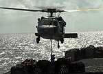 A Crewmember Aboard Dry Cargo/ Ammunition Ship USNS Richard E. Byrd (T-AKE 4) Attaches a Pallet Cable