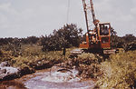 This photograph shows a dragline being used to cle
