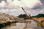 This 1976 photograph shows a dragline clearing deb