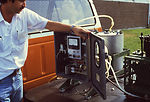 This 1981 image depicts a field technician inspect