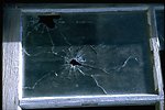 Window pane with bullet hole at Shirk Ranch.