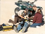 Law Enforcement Ranger using his EMT skills on a victim in the Imperial Sand Dunes