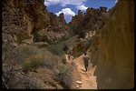 Leslie Gulch Series: visitors walking down small trail.