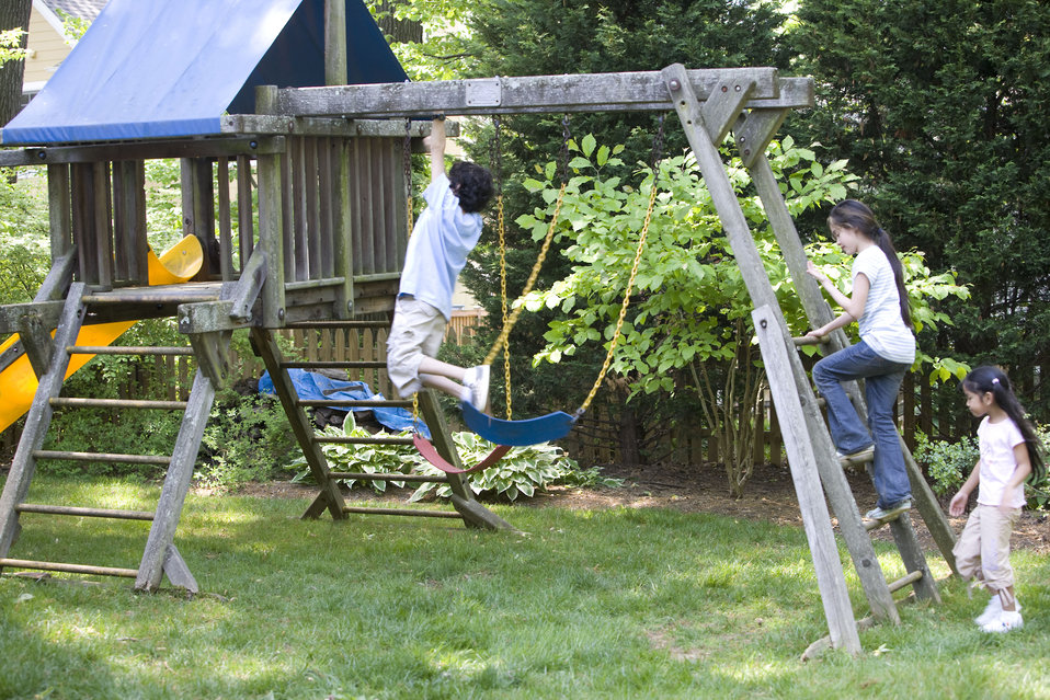 Children love playing outside, and these children were thoroughly enjoying their wooden swing set, and all were having fun in the fresh outd