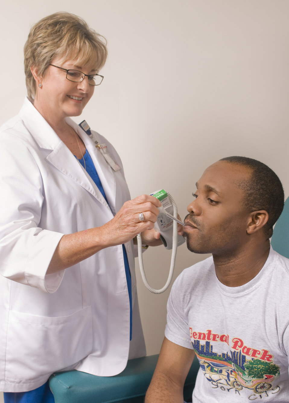 Seated in a clinical setting during his physical examination, this image depicts a male patient who was in the process of having his body te