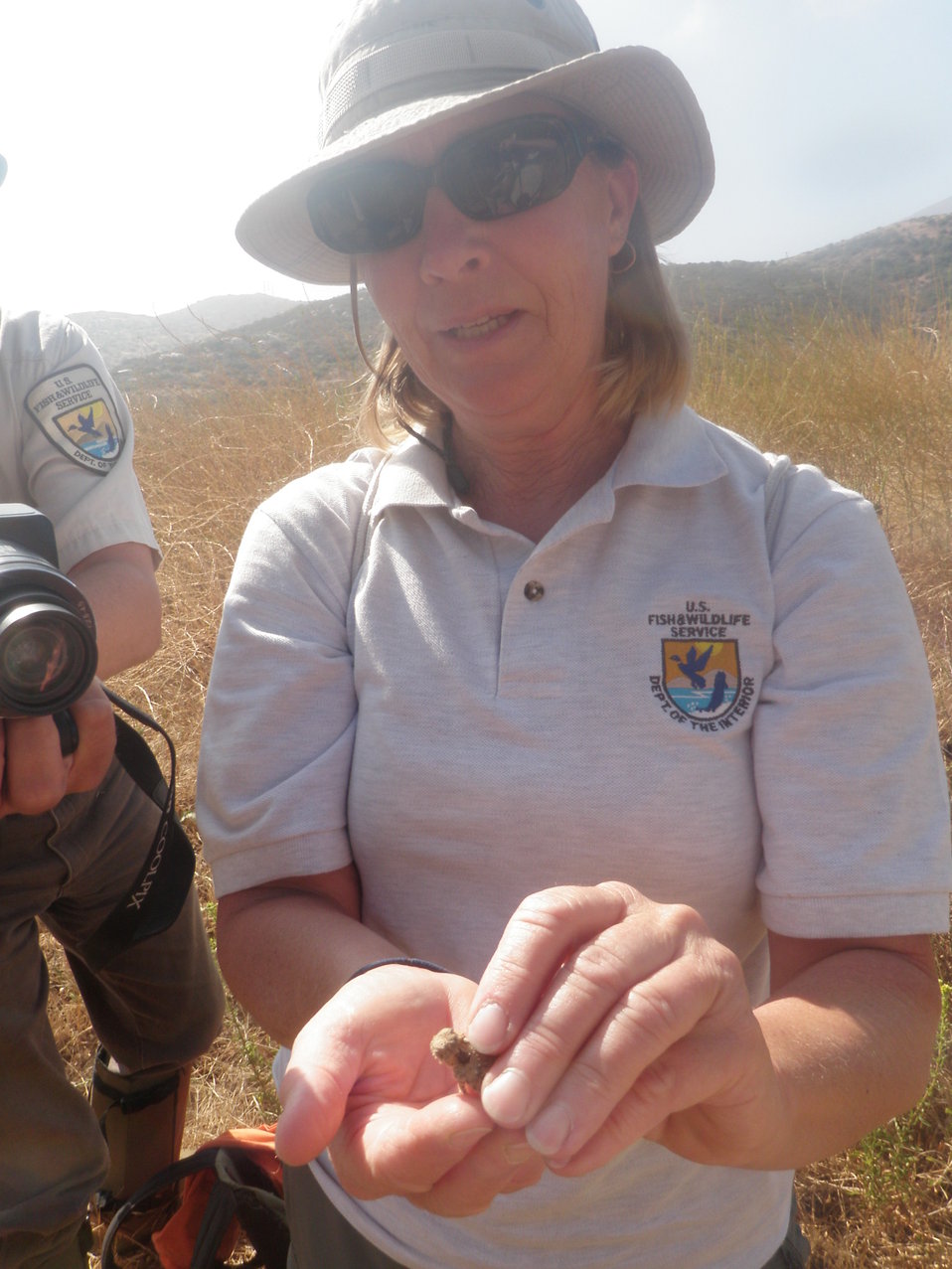 Refuge Manager Jill Terp shows a young San Diego horned lizard to other Refuge staff