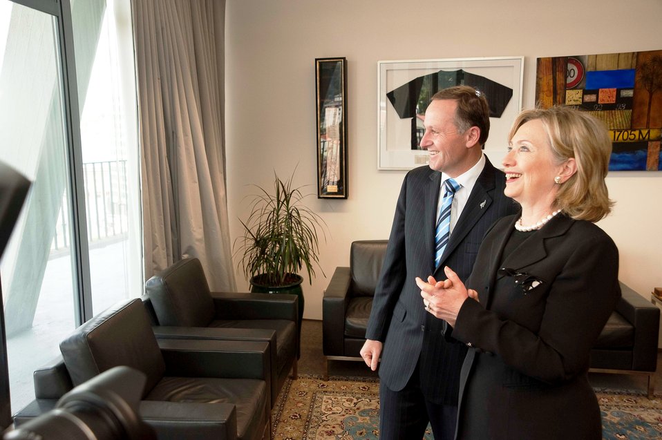 Secretary Clinton Looks at a Photo on the Wall