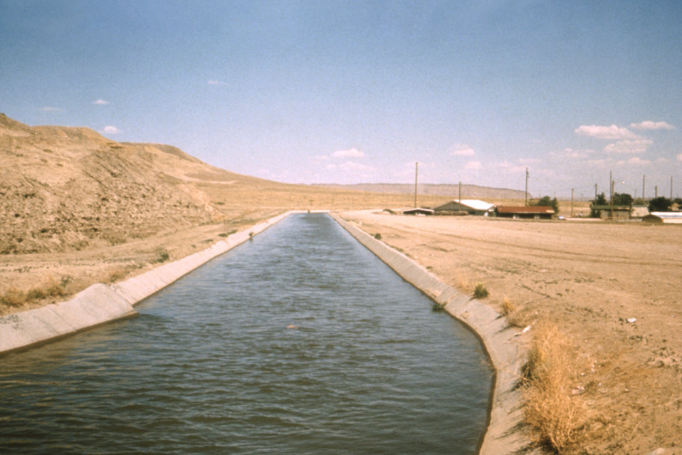 This is a 1976 photograph showing an irrigation distribution canal in New Mexico.