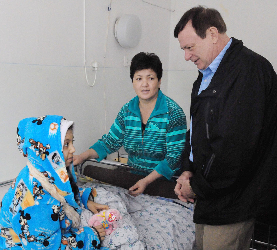 Chaplain (Lt. Col.) James Kinsey speaks to Firuza Nurahunova, a 13-year-old Kyrgyz girl, and her mother, Shakura, March 21, 2010, at the Tra