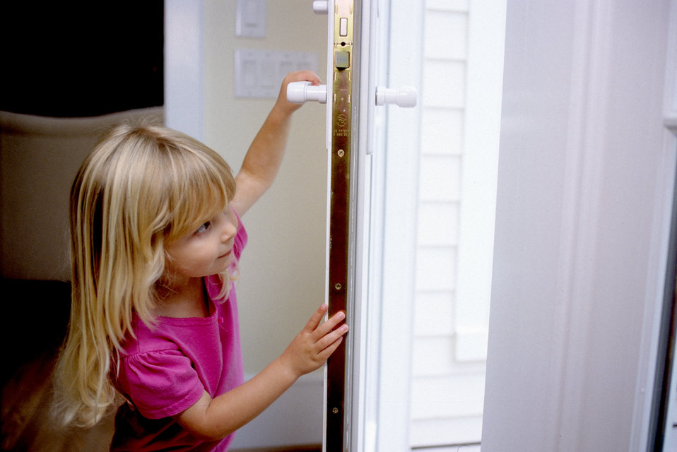 Young girl opening a door