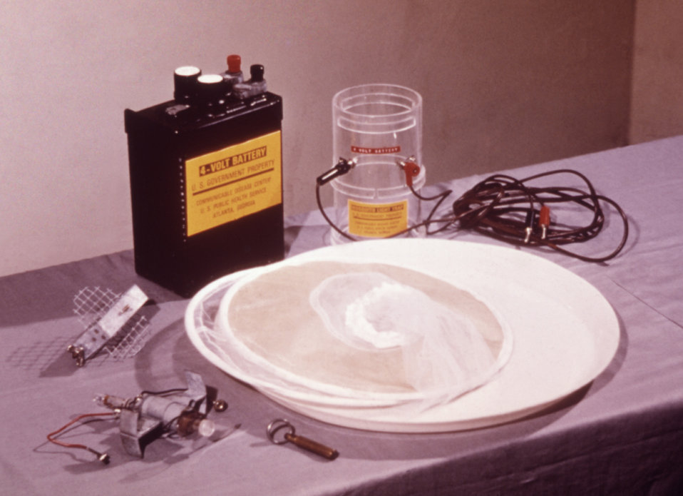 This photograph shows a disassembled CDC portable light trap used for catching mosquitoes.