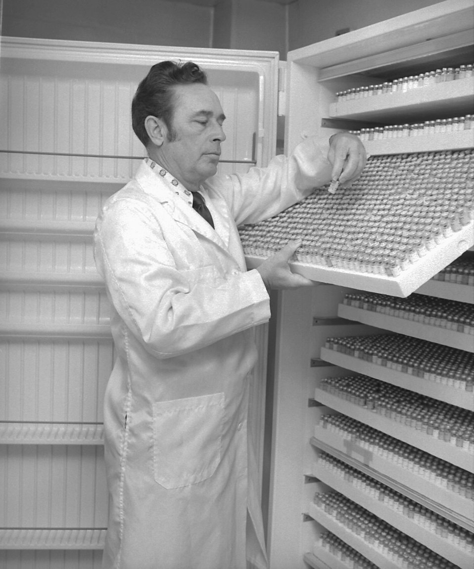 Lab technician Chuck Peters examines the labels on stored serum vials, 1977.