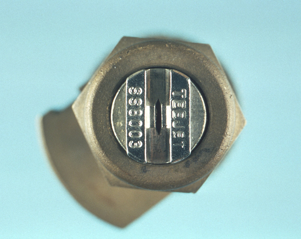 This photograph depicts an enlarged view of the exit port of a TeeJet SS8003 spray nozzle through which passes an insecticidal spray.