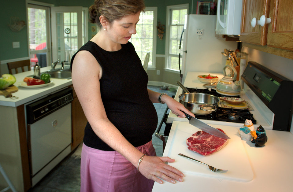 This photograph showed a pregnant woman using a kitchen knife to cut raw meat before cooking.  Pregnant women or immunosuppressed patients c