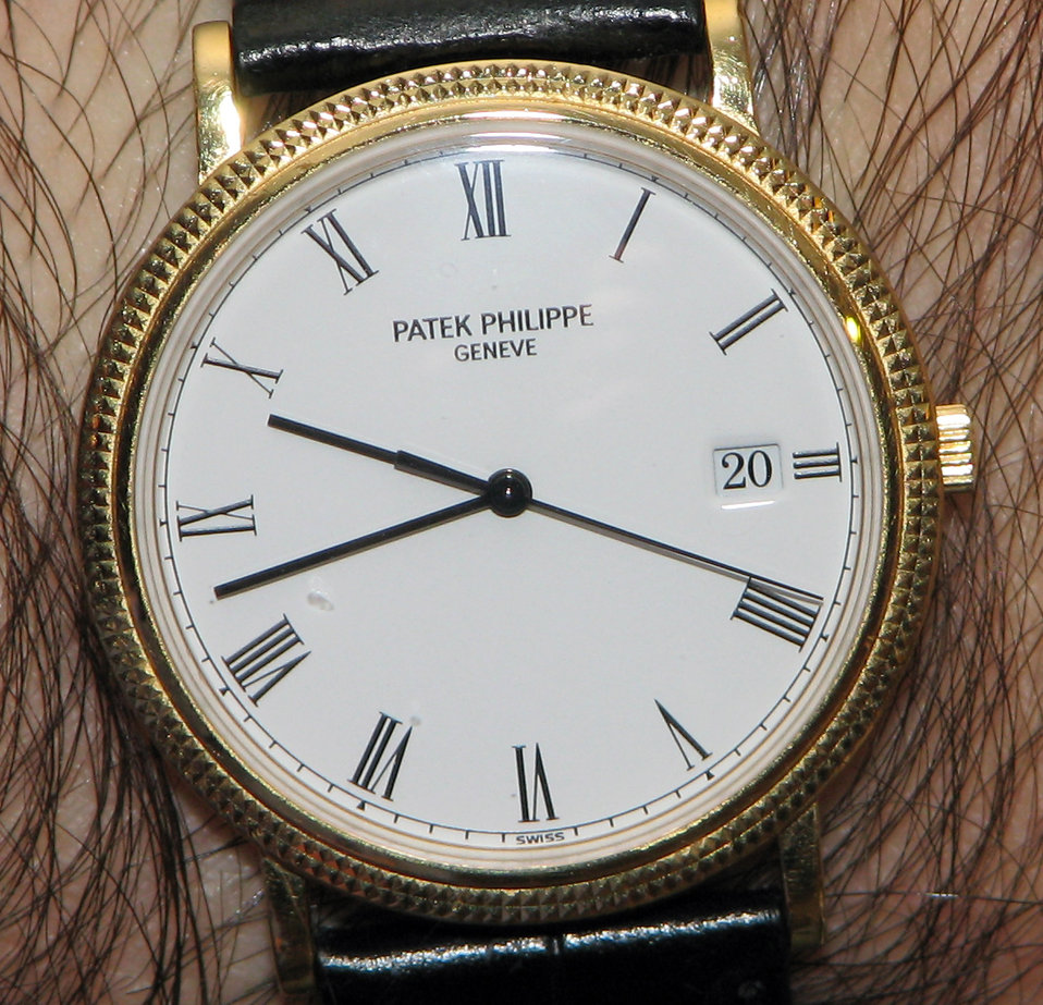 A circa 1999 men's quartz Calatrava, a dress watch built by the premier Swiss watchmaker Patek Philippe. It is in yellow gold, with a second hand and date