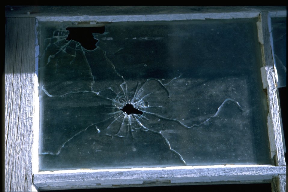Window pane with bullet hole at Shirk Ranch.