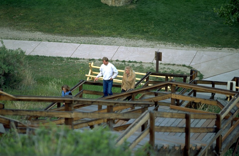 Visitors climbing the stairs of the boardwalk to view the signature of Captain William Clark at Pompeys Pillar