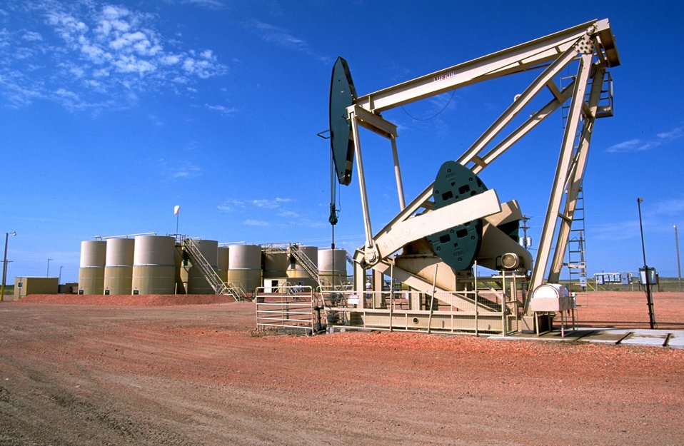 Cotes central tank battery with pump in foreground