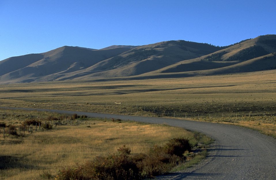 Centennial Valley road with mountains in the background